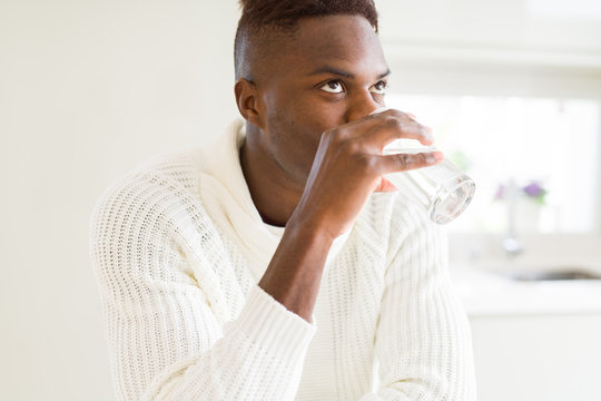 Young african american man drinking a fresh glass of water