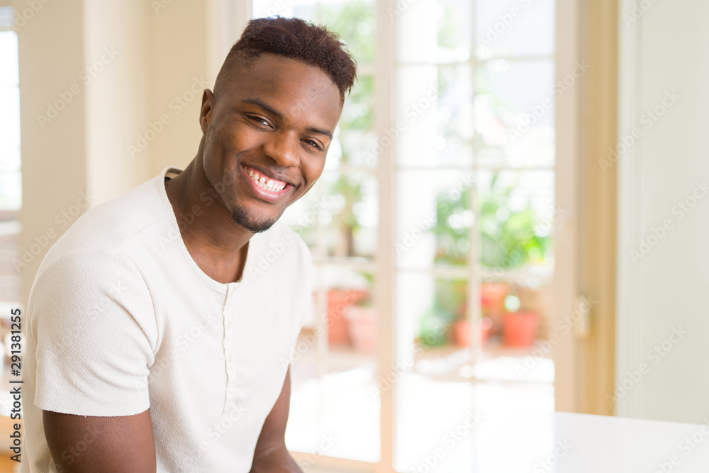 Poster Handsome african young man smiling cheerful with a big smile on face