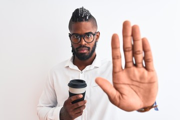 African american businessman with braids drinking coffee over isolated white background with open hand doing stop sign with serious and confident expression, defense gesture