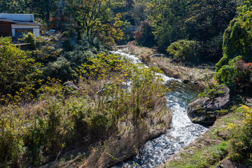 Fototapeta na wymiar Mitake Shosenkyo Gorge Autumn foliage scenery view in sunny day. Beauty landscapes of magnificent fall colours. A popular tourist attractions in Kofu, Yamanashi Prefecture, Japan