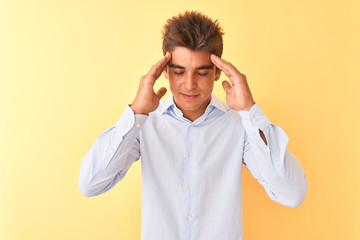 Young handsome businessman wearing elegant shirt over isolated yellow background with hand on head for pain in head because stress. Suffering migraine.