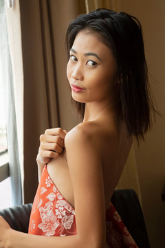 Philippine woamn posing nude in a black chair
