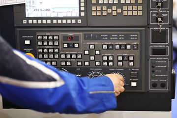 operator adjusts the parameters of CNC machine