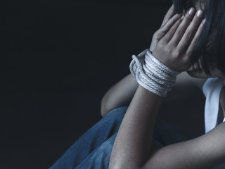 Kidnapped little girl tied with rope.Abused and tortured concept. Human trafficking concept. Stop violence against human. Stop abusing violence.