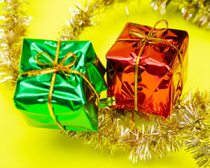 Tinsel Garland isolated on bright yellow background. Christmas gift decoration. Winter Holidays concept.