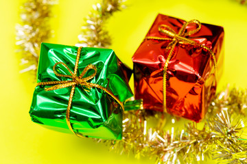 Tinsel Garland isolated on bright yellow background. Christmas gift decoration. Winter Holidays concept.