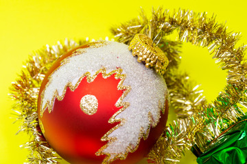 Tinsel Garland and Vintage Christmas Tree Ball isolated on bright yellow background. Winter Holidays Decoration concept.