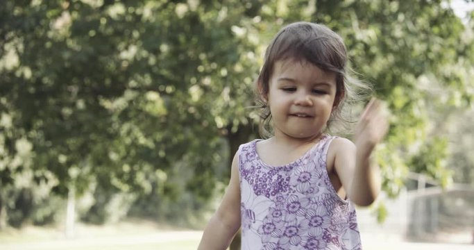 Cute baby girl exploring a park in late summer. Shot in 4K RAW on a cinema camera.