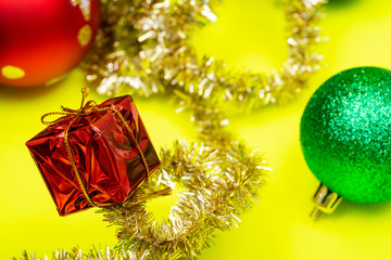 Tinsel Garland and Vintage Christmas Tree Ball isolated on bright yellow background. Winter Holidays Decoration concept.