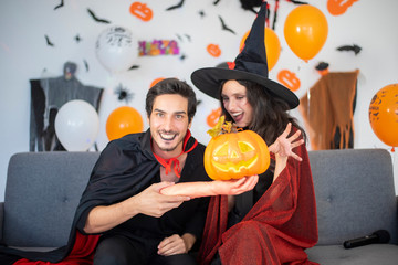 Fototapeta premium happy couple of love in costumes and makeup on a celebration of Halloween