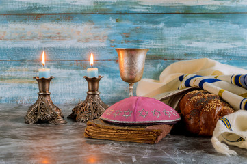 Obraz na płótnie Canvas Shabbat challah bread, shabbat wine and candles on the table. Top view