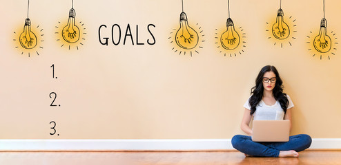 Goal list with young woman using a laptop computer
