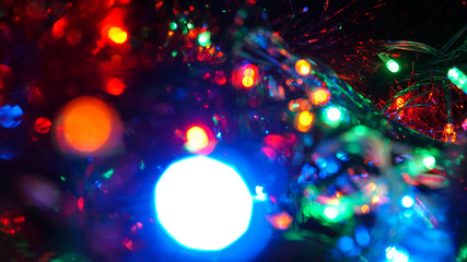Christmas colorful New Year's Bokeh neon lights. Abstract Blurred photo background with blinking...
