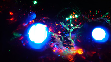 Christmas colorful New Year's Bokeh neon lights. Abstract Blurred photo background with blinking...