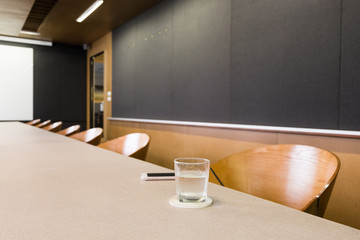 empty meeting room with a glass of water.