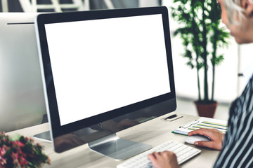 Business woman using computer with white mockup blank screens in modern work loft