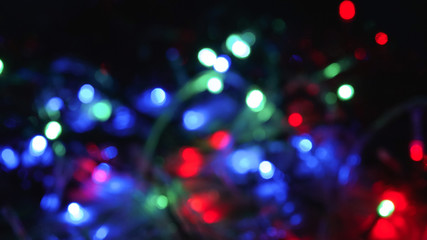 Christmas colorful New Year's Bokeh neon lights. Abstract Blurred photo background with blinking...
