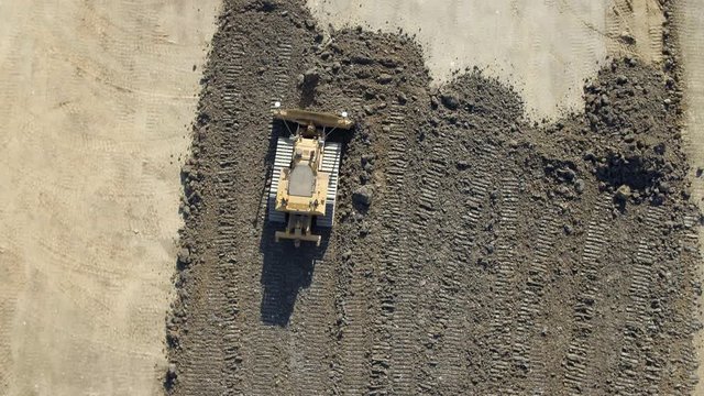 Bulldozer Working to Flatten Earth During Groundworks on a Construction Site