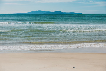 sunny pristine and deserted beach overlooking the South Pacific Ocean