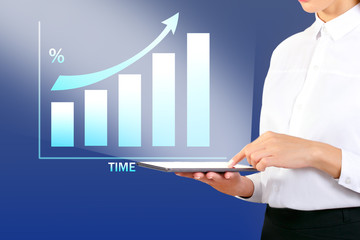 Woman With Tablet Pc At Office And Growth Chart. Businesswoman showing a growth chart.
