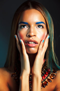 young pretty modern african american girl with bright fashion makeup and ethnic jewelry