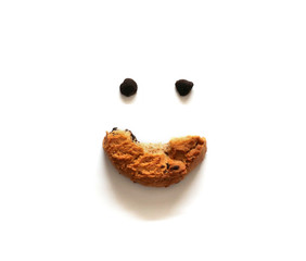 Smiling bitten chocolate chip cookie isolated on white background. Positive inspirational about happy.