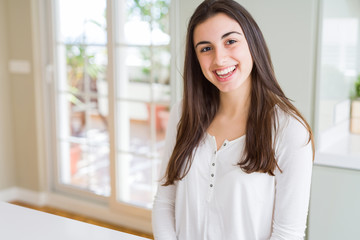 Beautiful young brunette woman smiling cheerful looking at the camera with a big smile on face showing teeth