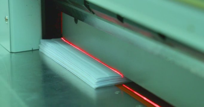 Industrial paper cutting machine cuts extra paper from paper sheets