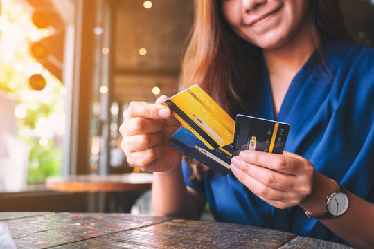 Closeup image of a woman holding and choosing credit card to use