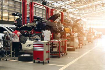 Fototapeta premium mechanic working car maintenance with soft-focus and over light in the background