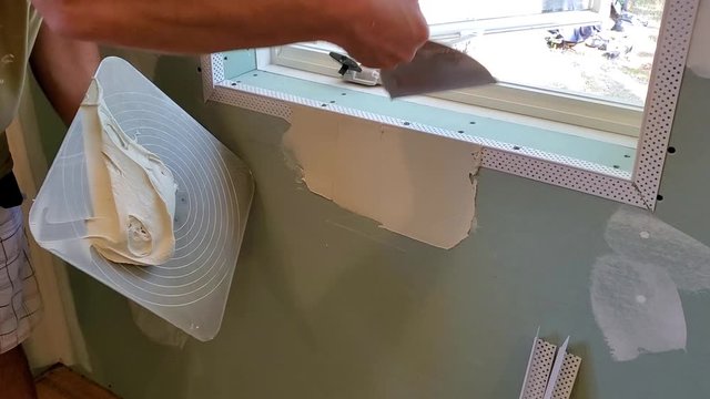 Carpenter spackling wall 
