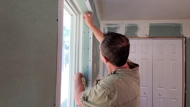 Handyman installing window