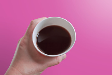 Close-up of a person drinking coffee in a paper cup.  紙コップでコーヒーを飲む人のクローズアップ