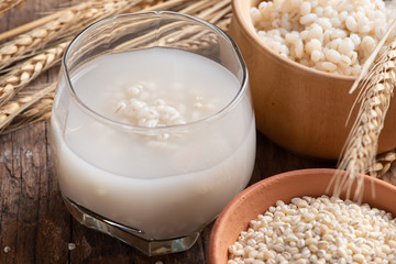 Barley water in glass with raw and cooked