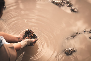 The little boy waiting for drinking water to live through this drought, Concept drought and crisis environment.