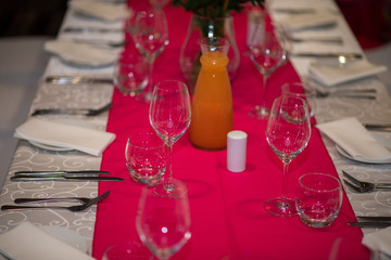 Empty table with glasses and cutlery arranged