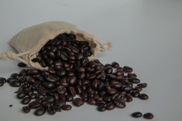 Many roasted coffee beans are in the coffee bags and stacked