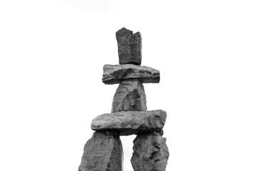 Inukshuk isolated on white background. Human-made stone landmark.