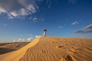 Portrait Young Asian Woman travel, On White Sand dune desert Muine, in Vietnam