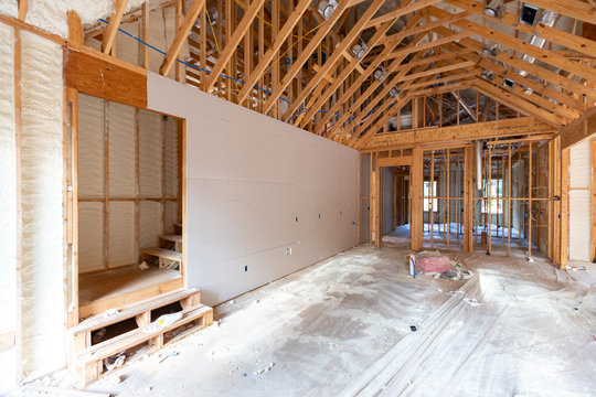 Room in home, under contruction, with spray foam and drywall visible