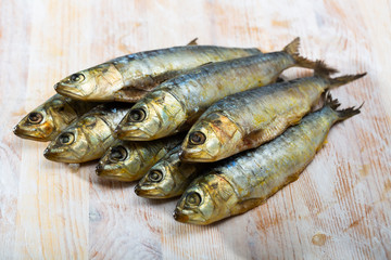 Salted sardines on wooden surface