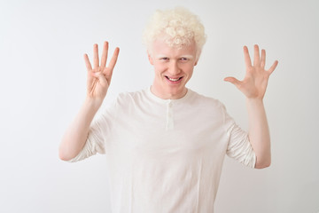 Young albino blond man wearing casual t-shirt standing over isolated white background showing and pointing up with fingers number nine while smiling confident and happy.