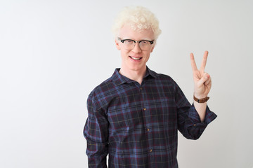 Young albino blond man wearing casual shirt and glasses over isolated white background showing and pointing up with fingers number two while smiling confident and happy.