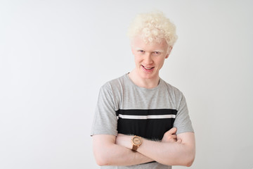 Young albino blond man wearing casual t-shirt standing over isolated white background happy face smiling with crossed arms looking at the camera. Positive person.