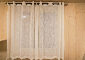 close up transparent white curtain at bedroom window in vintage wooden house