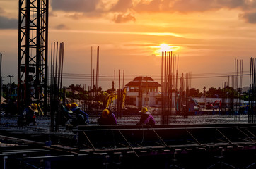 Silhouette worker on site construction with sunset time backgeound