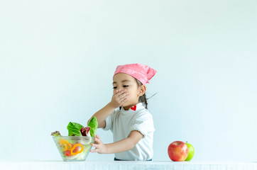 Little girl do not eat vegetable with isolated on white(health concept)