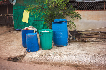 Four plastic recycling bins on the street