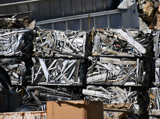 Stack of crushed and cube formed metal aluminum at recycling