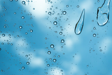 Rain on the window, natural skin of the rain The natural form of rainwater on a sky background.